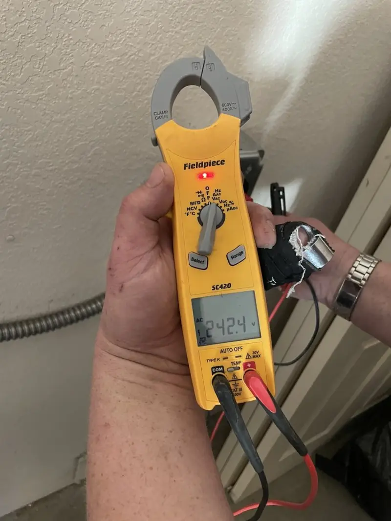 Voltage testing with clamp meter during Outlet Installation in Flushing